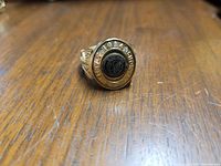 Top view of the 2012 Stanley Cup ring showing the round black center with Molson logo and engraved text around the edge.