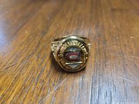 Front view of gold-tone ring displaying enamel Montreal Canadiens logo surrounded by simulated diamonds