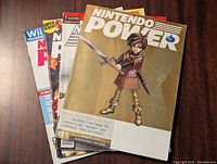 Top view of several Nintendo Power magazines stacked with issue 257 on top showing a character holding a sword.