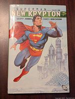 Front cover showing Superman flying in front of a Kryptonian cityscape with title and author names.