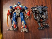 Front view of Optimus Prime and Jetfire action figures showing colors and details.
