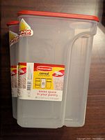 Two Rubbermaid cereal containers stacked, showing the front label with brand, capacity, and flip-top lid feature.