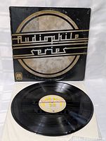 Front cover of the vintage 'Audiophile Series' vinyl record showing wear and aging with black and silver design.