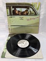Front cover of Cheech & Chong Los Cochinos LP showing the duo inside a car with cactus background and a price tag sticker.