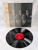 Photo of the vinyl LP record outside the album cover, showing the red Vanguard label and black vinyl disc.