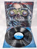 Front view of the Jethro Tull Stormwatch LP cover and opened vinyl showing label