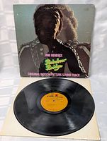 Vinyl record with orange label and album cover featuring Jimi Hendrix.