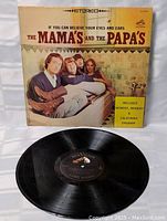 Front cover and record visible, showing the band's image and album title "If You Can Believe Your Eyes and Ears" with promotional sticker for hit songs.