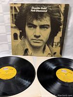 Photo of the Double Gold Neil Diamond album cover and two vinyl records with RCA labels, showing the overall content of the lot.