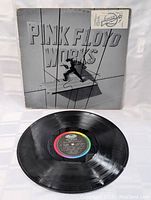 Front of Pink Floyd Works album cover with visible sticker and gray 3D style text design.
