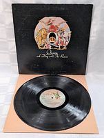 Vinyl record on cardboard inner sleeve, showing the label and side of the record, the record appears in good condition with some reflection light spots.