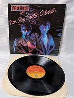 Photo showing the vintage vinyl record LP and cover. The cover art features the two band members under colorful lighting with 'Soft Cell Non-Stop Erotic Cabaret' text.