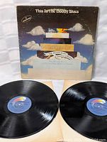 Front of album cover with artwork showing title 'This Is The Moody Blues' and visible wear on edges and surface