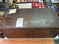 Closed wooden cabinet showing top surface and label holder