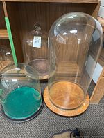 Overall view of three glass domes with bases