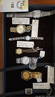 Tray overview showing seven watches in a foam insert