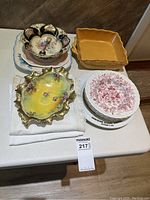 Full view of all serving dishes, bowls, bakeware dishes and linens arranged on a table