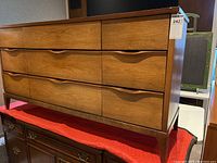 Front view of mid-century modern dresser showing six drawers and tapered legs