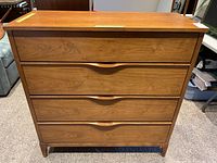 Front view of four-drawer walnut veneer dresser