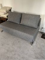 Front view of sofa in upright seating position showing fabric and cushions