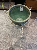 Top view showing the green ceramic pot interior and label with measurements.