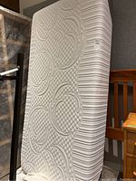 Side view of the Serta iComfort twin mattress showing quilted circular and linear patterns.