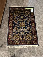 Top view of small area rug showing floral design and colors