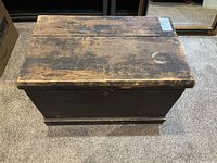 Top view of vintage wood chest showing worn and distressed condition.