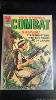 Front cover photo showing full comic book titled 'War Stories Combat Saipan' from Dell Comics, bright colors with soldier illustration.