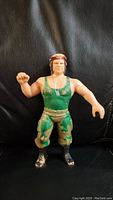 Front view of Corporal Kirchner LJN wrestling figure showing green tank top, camo pants, and red beret.
