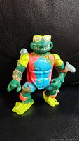 Front view of the 1990 Ninja Turtles Sewer Surfer Mike toy showing vibrant colors and details
