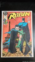 Front cover of the Robin comic book with Batman and Robin, showing title and DC Comics logo.