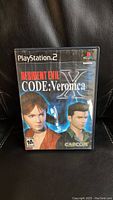 Front cover of Resident Evil Code: Veronica X PS2 game case showing main characters and branding.