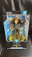 Front view of the sealed Black Adam figure in box with throne accessory, packaging labeled for ages 12+, includes 22 moving points of articulation.