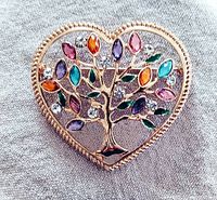 Front view of the gold-plated heart-shaped pin showing the detailed "Tree of Life" design with multicolored gemstones set on the branches.