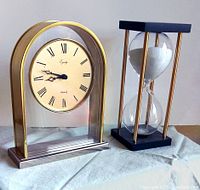 Both vintage mantle clock and full-sized hourglass side by side showing the overall lot