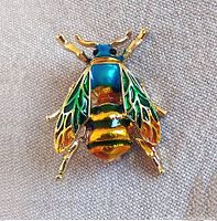 Front view of the blue and gold honey bee brooch showing colorful enamel details on wings and body.
