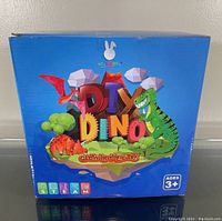 Front view of blue box with colorful dinosaur graphics and the words 'DIY Dino Glow In The Dark'.