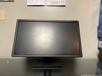 Front view of the Dell 24-inch widescreen monitor on a stand, showing the screen and frame.