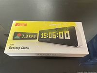 Photo of Ulanzi TC001 desktop clock box showing digital clock image and features on front.