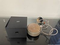 Image of Native Union box and wireless charging station with attached cable and power plug.