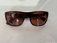 Front view of men's Serengeti sunglasses showing tortoiseshell frame and brown lenses.