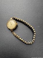 Full view of the vintage ladies Longines gold plated manual wind watch with linked bracelet.