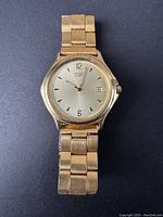 Front view of vintage Citizen men's watch showing gold-tone metal case and bracelet with champagne dial and date display.