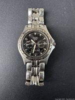 Front view of vintage men's Guess watch showing stainless steel band and bezel with minute markers