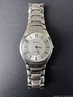 Front view of entire silver-tone watch showing linked bracelet and round watch face with hour markers and hands