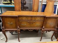 Full frontal view of sideboard showing overall shape, top surface, and central drawers