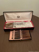 Full view of carving set and steak knives in original boxes, showing Bakelite handles and stainless steel blades