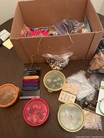Full view of box containing beads, hemp cords, and other jewelry making supplies.