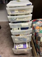 Full view of the large plastic storage cart with six drawers containing scrapbooking materials.